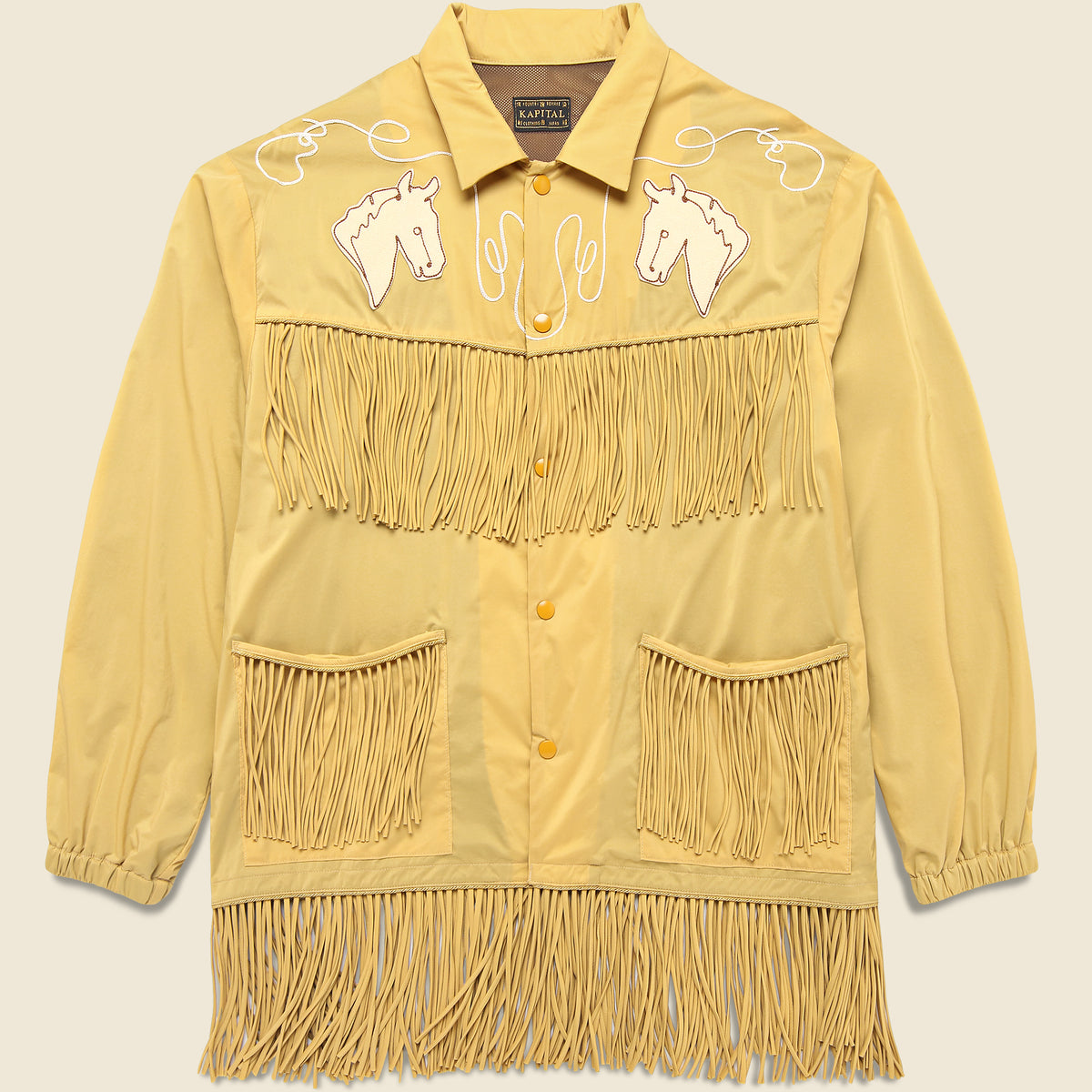 Kapital Fringed Coach Jacket in Mustard featuring a relaxed fit and distinctive fringe detailing.