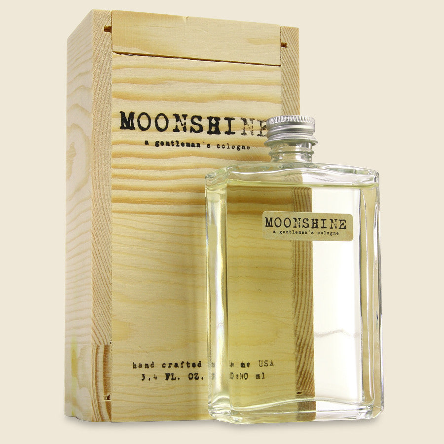 Moonshine Cologne by EastWest Bottlers featuring a woodsy fragrance with notes of black pepper, tobacco, leather, gin, and patchouli.